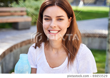 Woman with bottle of fresh water 69853529