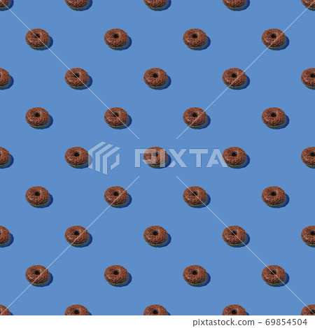 Chocolate brown donuts with sprinkles, sweet glazed dessert seamless pattern on blue background 69854504