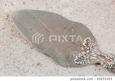 Old brass spatula on concrete background 69855493