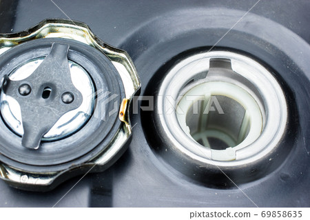 A close up view in fuel tank of motor cultivator. garden works concept A close up view in fuel tank of motor cultivator. garden works concept 69858635