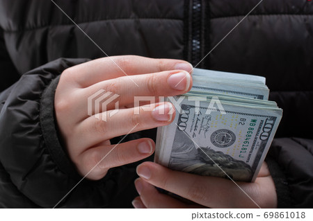 Hands holding cash USD dollar banknotes. Currency, Cash, Bill Concept Hands holding cash USD dollar banknotes. Currency, Cash, Bill Concept 69861018