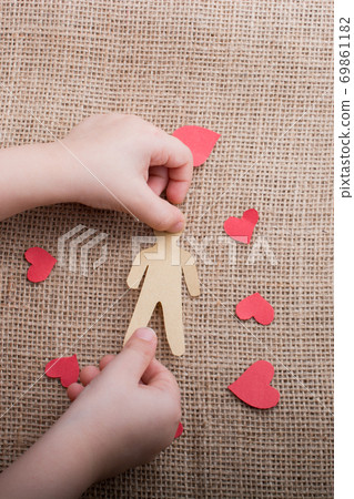 Paper man shape in hand in the view 69861182