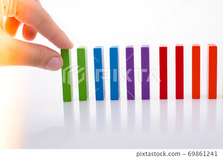 Hand holding color dominoes Hand holding color dominoes 69861241