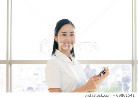 A smiling female nurse [portrait] 69861541
