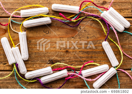 Colorful tampons with a natural wood grain background 69861802