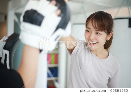 Woman hitting a mitt 69861980