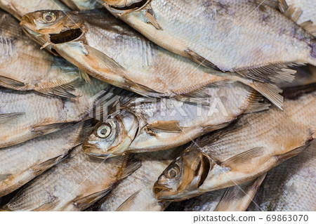 Dried fish background. Salty dry river fish top view with copy space 69863070