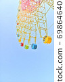 Clear blue sky and colorful Ferris wheel 69864640