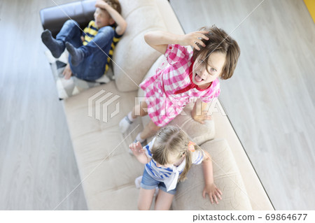 Children play and jump on couch and have fun. Children play and jump on couch and have fun. 69864677