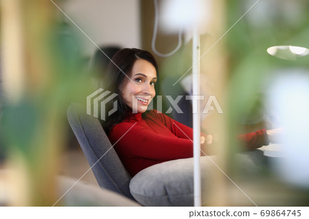 Smiling woman sitting chair doing manicure services closeup 69864745