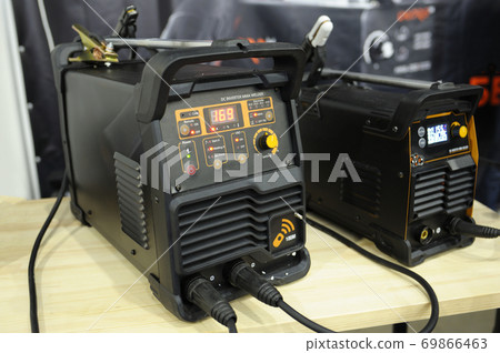 At the workshop. DC inverter MMA welder, household electric welding machine, placed on the table At the workshop. DC inverter MMA welder, household electric welding machine, placed on the table 69866463