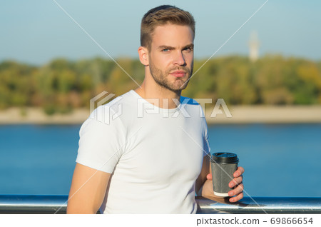Takeaway coffee is my lifestyle. Handsome man hold coffee cup outdoors Takeaway coffee is my lifestyle. Handsome man hold coffee cup outdoors 69866654