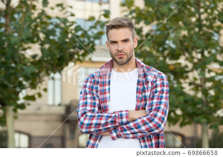 Good looking guy stand outdoors with crossed arms Good looking guy stand outdoors with crossed arms 69866658