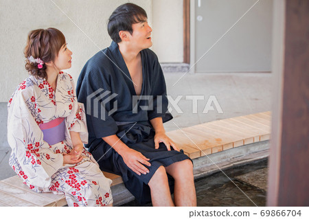 Men and women taking a footbath Men and women taking a footbath 69866704