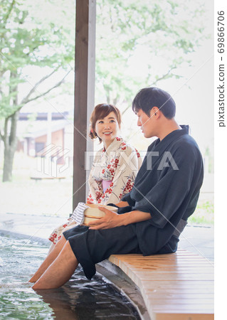 Men and women taking a footbath Men and women taking a footbath 69866706