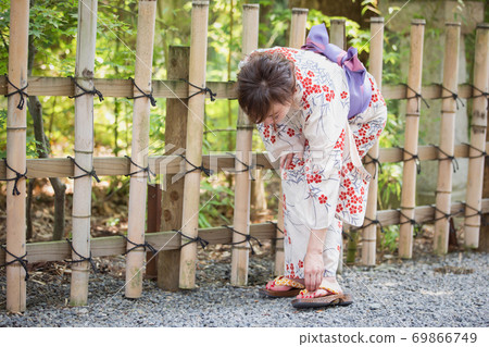 Woman fixing clogs 69866749