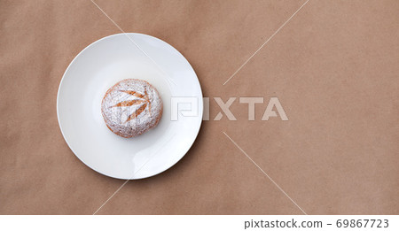 Pattern of cannabis leaf made with powdered sugar on the cookies on kraft background. Cannabis live resin extraction. Banner 69867723