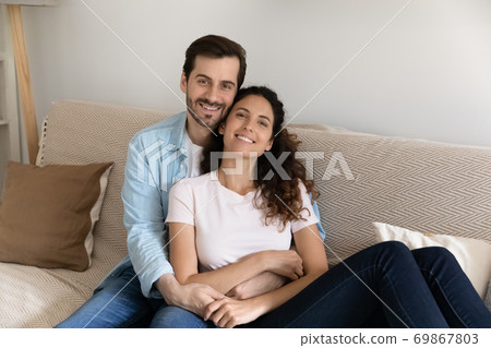 Portrait of happy couple renters relax on couch Portrait of happy couple renters relax on couch 69867803