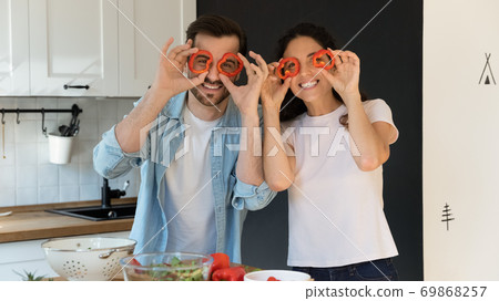 Portrait of happy couple have fun cooking at home kitchen 69868257