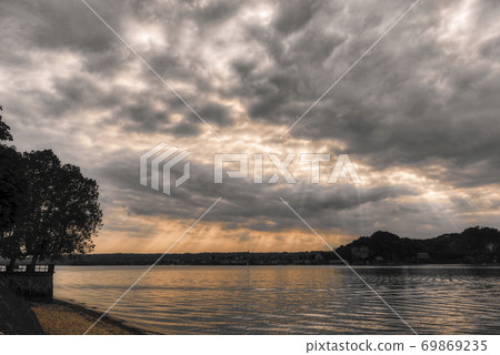 cloudy sunset over the lake cloudy sunset over the lake 69869235