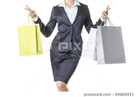Businesswoman holding a few shopping bags. Isolated on white background. Businesswoman holding a few shopping bags. Isolated on white background. 69869953