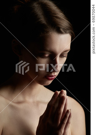 sad woman praying sad woman praying 69870044