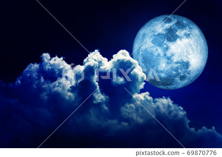 Full moon in blue lighting night sky background with clouds. 69870776