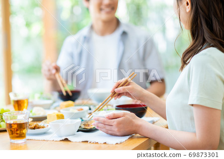 Young couple eating breakfast Young couple eating breakfast 69873301