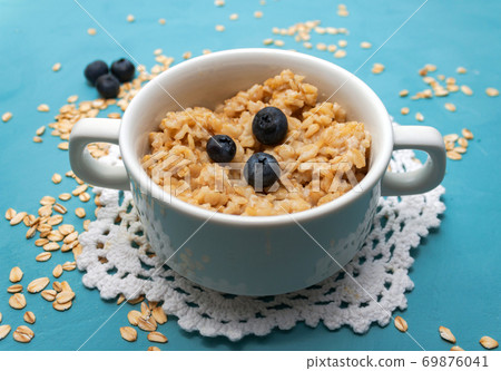 Oatmeal porridge with fresh blueberries in white 69876041
