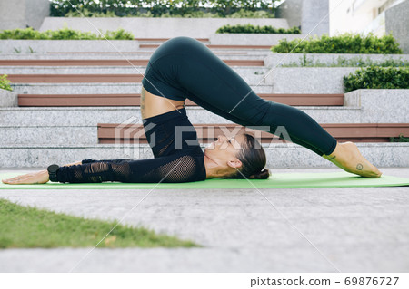 Woman doing plow pose Woman doing plow pose 69876727