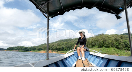 Tourist Asian young woman sitting on boat travel as dream lifestyle people happy luxury trip in vacation Tourist Asian young woman sitting on boat travel as dream lifestyle people happy luxury trip in vacation 69878438
