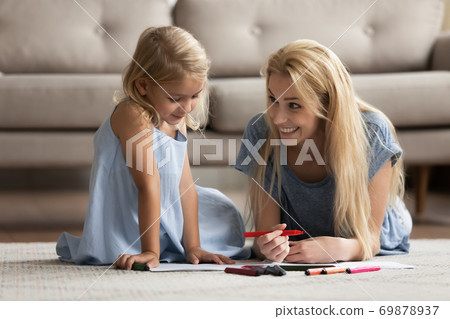 Happy young mother and daughter kid drawing pictures in album 69878937