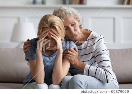 Anxious loving aged hoary mother soothing stressed suffering grown daughter 69879039