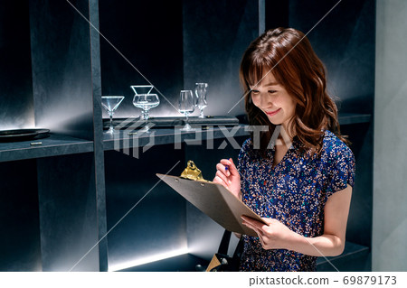 Young female staff with documents working in the store 69879173