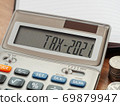 Tax word and 2021 number on calculator. Business and tax concept. Pay tax in 2021 years. 69879947