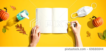 Notebook with a mask and a sanitizer bottle Notebook with a mask and a sanitizer bottle 69880844