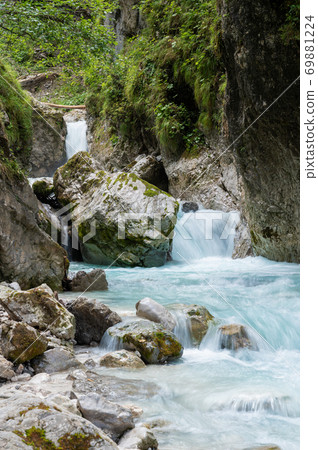 Beautiful mountain stream flowing through rocks and stones Beautiful mountain stream flowing through rocks and stones 69881224