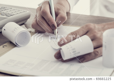 Accountant working at her desk Accountant working at her desk 69881225