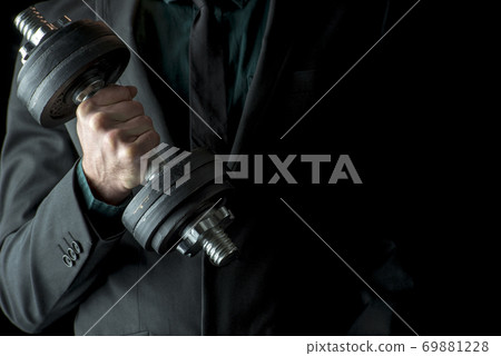 A businessman doing dumbbell biceps curl A businessman doing dumbbell biceps curl 69881228