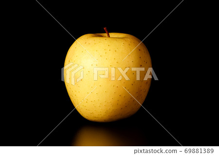 yellow Apple on a black background close-up.isolate 69881389