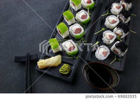 Seafood delicatessen sushi rolls set on plates. Seafood delicatessen sushi rolls set on plates. 69882035