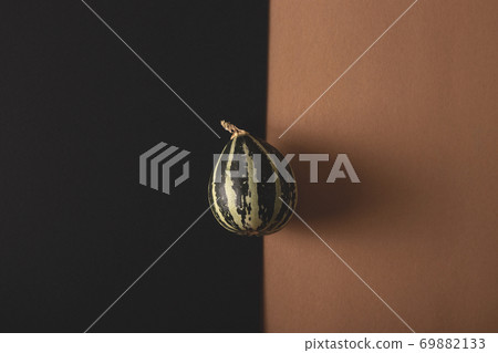 Mini pumpkin on a combined background. Halloween concept Mini pumpkin on a combined background. Halloween concept 69882133