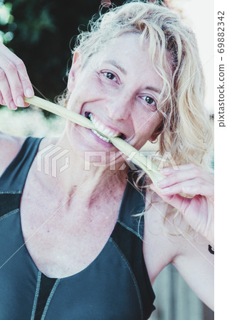 Woman biting celery Woman biting celery 69882342