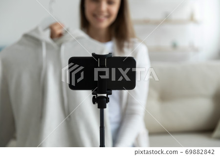 Close up of woman shoot clothes unpacking on cellphone Close up of woman shoot clothes unpacking on cellphone 69882842