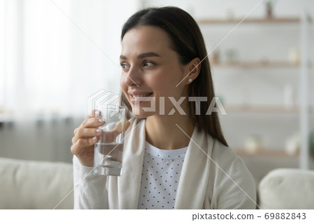 Smiling young woman enjoy clean mineral water 69882843