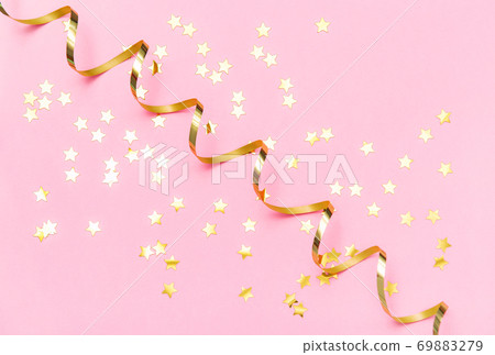 Pink color flat lay background Golden confetti serpentine 69883279