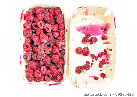 Full and empty box with fresh red raspberries 69883420