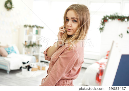 Portrait of attractive smiling woman at home - Christmas decoration Portrait of attractive smiling woman at home - Christmas decoration 69883487