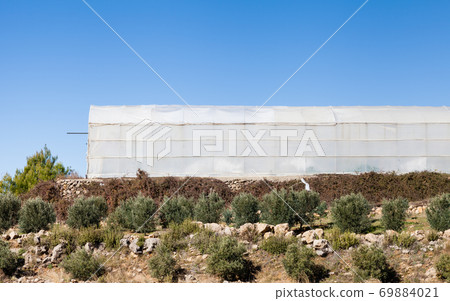 Greenhouse. An industrial greenhouse on a farm in Turkler in the province of Alanya, southern Turkey. Greenhouse. An industrial greenhouse on a farm in Turkler in the province of Alanya, southern Turkey. 69884021