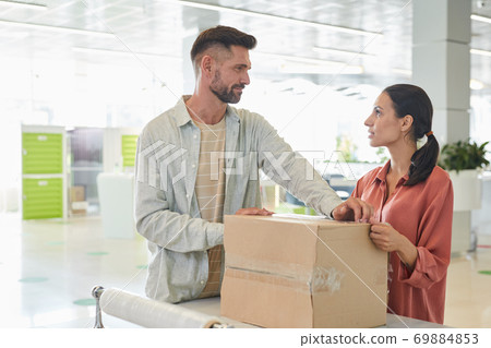 Adult Couple Packing Boxes Together 69884853